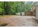 Spacious backyard with an enclosed fence, brick, storage shed, and wooded perimeter at 2950 Duke Of Gloucester, Atlanta, GA 30344