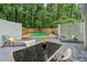 A backyard oasis features a pool, seating, green foliage and privacy fencing at 2950 Duke Of Gloucester, Atlanta, GA 30344