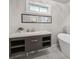 Modern bathroom featuring a floating vanity, soaking tub, and a well-lit, minimalist design at 2950 Duke Of Gloucester, Atlanta, GA 30344