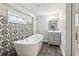 Bathroom with a freestanding tub, decorative tile wall, and a modern vanity at 2950 Duke Of Gloucester, Atlanta, GA 30344