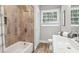 Bathroom featuring tub/shower combo, modern vanity, and wood-look flooring at 2950 Duke Of Gloucester, Atlanta, GA 30344