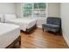 Cozy bedroom featuring hardwood floors, natural light, and a comfortable chair at 2950 Duke Of Gloucester, Atlanta, GA 30344
