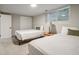 A bright bedroom features two beds with neutral bedding, light colored carpet, and a window at 2950 Duke Of Gloucester, Atlanta, GA 30344