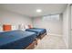 Bedroom featuring two twin beds with blue comforters, and a modern minimalistic decor at 2950 Duke Of Gloucester, Atlanta, GA 30344