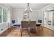 Bright dining room with modern chandelier, hardwood floors, and stainless steel accents at 2950 Duke Of Gloucester, Atlanta, GA 30344