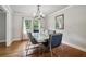 Bright dining room with modern chandelier, hardwood floors, and stainless steel accents at 2950 Duke Of Gloucester, Atlanta, GA 30344