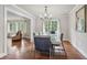 Open dining room with chandelier and hardwood floors leading to a living area with bright window at 2950 Duke Of Gloucester, Atlanta, GA 30344