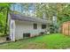 Back of property with grassy lawn, mature landscaping, and patio at 2950 Duke Of Gloucester, Atlanta, GA 30344
