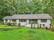 Charming single-story home featuring a well-manicured lawn and lush greenery, perfect for suburban living at 2950 Duke Of Gloucester, Atlanta, GA 30344