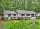 Lovely home with beautiful landscaping, including vibrant greenery, mulch beds, and a winding pathway at 2950 Duke Of Gloucester, Atlanta, GA 30344