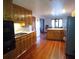 Open kitchen with wood cabinets, center island, and hardwood floors at 9031 Thornton Rd, Jonesboro, GA 30236