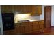 Traditional kitchen with wood cabinets, built-in oven, cooktop, and elegant countertops at 9031 Thornton Rd, Jonesboro, GA 30236