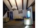 Open living room featuring vaulted ceilings, exposed beams, and lots of natural light at 9031 Thornton Rd, Jonesboro, GA 30236