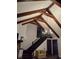 Dramatic living room featuring a vaulted ceiling, wood beams, and stone fireplace at 9031 Thornton Rd, Jonesboro, GA 30236