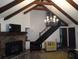 Spacious living room featuring vaulted ceilings, wooden beams, a stone fireplace, and staircase at 9031 Thornton Rd, Jonesboro, GA 30236