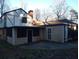 Exterior view of home with a screened porch, attached accessory building, and mature trees at 9031 Thornton Rd, Jonesboro, GA 30236