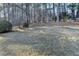 Lush backyard with mature trees and well-maintained lawn, offering privacy and space at 420 Woodbrook Way, Lawrenceville, GA 30043