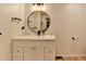Bathroom featuring a white vanity and an updated, round mirror at 420 Woodbrook Way, Lawrenceville, GA 30043