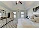 Bright bedroom showcases a tray ceiling, comfortable bed, and a stylish dresser, creating a cozy retreat at 420 Woodbrook Way, Lawrenceville, GA 30043