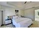 Bright bedroom features comfortable bedding, side tables and lamps, with a bathroom entrance for convenience at 420 Woodbrook Way, Lawrenceville, GA 30043