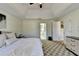 Bedroom view featuring a comfortable bed, bathroom entrance, and a dresser, all complimented by the ceiling fan at 420 Woodbrook Way, Lawrenceville, GA 30043