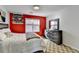 Stylish bedroom with a red accent wall, carpet, a cozy bed, and rustic wood dresser at 420 Woodbrook Way, Lawrenceville, GA 30043