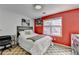 Contemporary bedroom featuring a bright red accent wall, cozy bed and a wood dresser at 420 Woodbrook Way, Lawrenceville, GA 30043