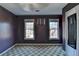 Bedroom featuring two windows, neutral carpet, and wall art providing ample natural light and a cozy atmosphere at 420 Woodbrook Way, Lawrenceville, GA 30043