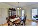 Inviting dining room featuring hardwood floors, a classic china cabinet, and ample natural light at 420 Woodbrook Way, Lawrenceville, GA 30043