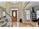 Welcoming foyer with hardwood floors and natural light showcasing the beautiful staircase at 420 Woodbrook Way, Lawrenceville, GA 30043