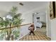 Hallway view featuring a wooden chair, plant, and glimpse of a bedroom with a cozy bed and carpet at 420 Woodbrook Way, Lawrenceville, GA 30043
