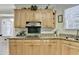 Kitchen area displaying wooden cabinets, granite countertops, and a stylish backsplash at 420 Woodbrook Way, Lawrenceville, GA 30043