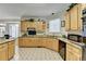 Well-lit kitchen featuring wood cabinets, granite countertops, and a patterned tile floor at 420 Woodbrook Way, Lawrenceville, GA 30043