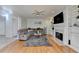 Living room with hardwood floors, a gray sectional, and a fireplace with built-in shelves at 420 Woodbrook Way, Lawrenceville, GA 30043