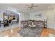Living room with hardwood floors, a gray sectional, and an open entryway to the dining area at 420 Woodbrook Way, Lawrenceville, GA 30043