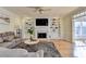 Bright living room with hardwood floors, fireplace, built-in shelving, and a ceiling fan at 420 Woodbrook Way, Lawrenceville, GA 30043