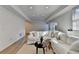 Bright living room with white sofa, wood flooring, and a wall-mounted television at 420 Woodbrook Way, Lawrenceville, GA 30043