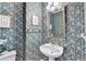 Traditional powder room with floral wallpaper, pedestal sink, and gold accents at 420 Woodbrook Way, Lawrenceville, GA 30043