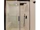 Tiled shower with glass door, a shower head and a seat at 420 Woodbrook Way, Lawrenceville, GA 30043