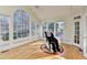 Bright sunroom with hardwood floors, many windows, and a massage chair at 420 Woodbrook Way, Lawrenceville, GA 30043