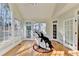 Bright sunroom with hardwood floors, natural light, and a massage chair, perfect for relaxation at 420 Woodbrook Way, Lawrenceville, GA 30043