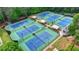 Community tennis courts are spacious and have manicured landscaping with mature trees and professional lighting at 420 Woodbrook Way, Lawrenceville, GA 30043