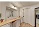 Vanity area with a large mirror, chair and wood-look flooring at 420 Woodbrook Way, Lawrenceville, GA 30043