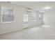 A well-lit bedroom provides ample space with neutral walls, light carpet, and a door leading to the outside at 4662 Creekside Villas Se Way, Smyrna, GA 30082