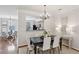 Elegant dining room with hardwood floors, chandelier, and pass-through view to a well-appointed kitchen at 4662 Creekside Villas Se Way, Smyrna, GA 30082