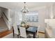 Chic dining area featuring dark wood table, chandelier lighting, and stairway views to the second floor at 4662 Creekside Villas Se Way, Smyrna, GA 30082