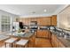 Well-lit kitchen features granite counters, wood cabinets, stainless appliances, and a kitchen island with seating at 4662 Creekside Villas Se Way, Smyrna, GA 30082