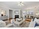 Open concept living room with a fireplace, hardwood floors, and seamlessly connected dining area at 4662 Creekside Villas Se Way, Smyrna, GA 30082