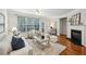 Inviting living room featuring hardwood floors, a fireplace, a large window and modern neutral decor at 4662 Creekside Villas Se Way, Smyrna, GA 30082