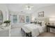 Light filled main bedroom featuring neutral decor, tray ceiling, and ample natural light at 4662 Creekside Villas Se Way, Smyrna, GA 30082